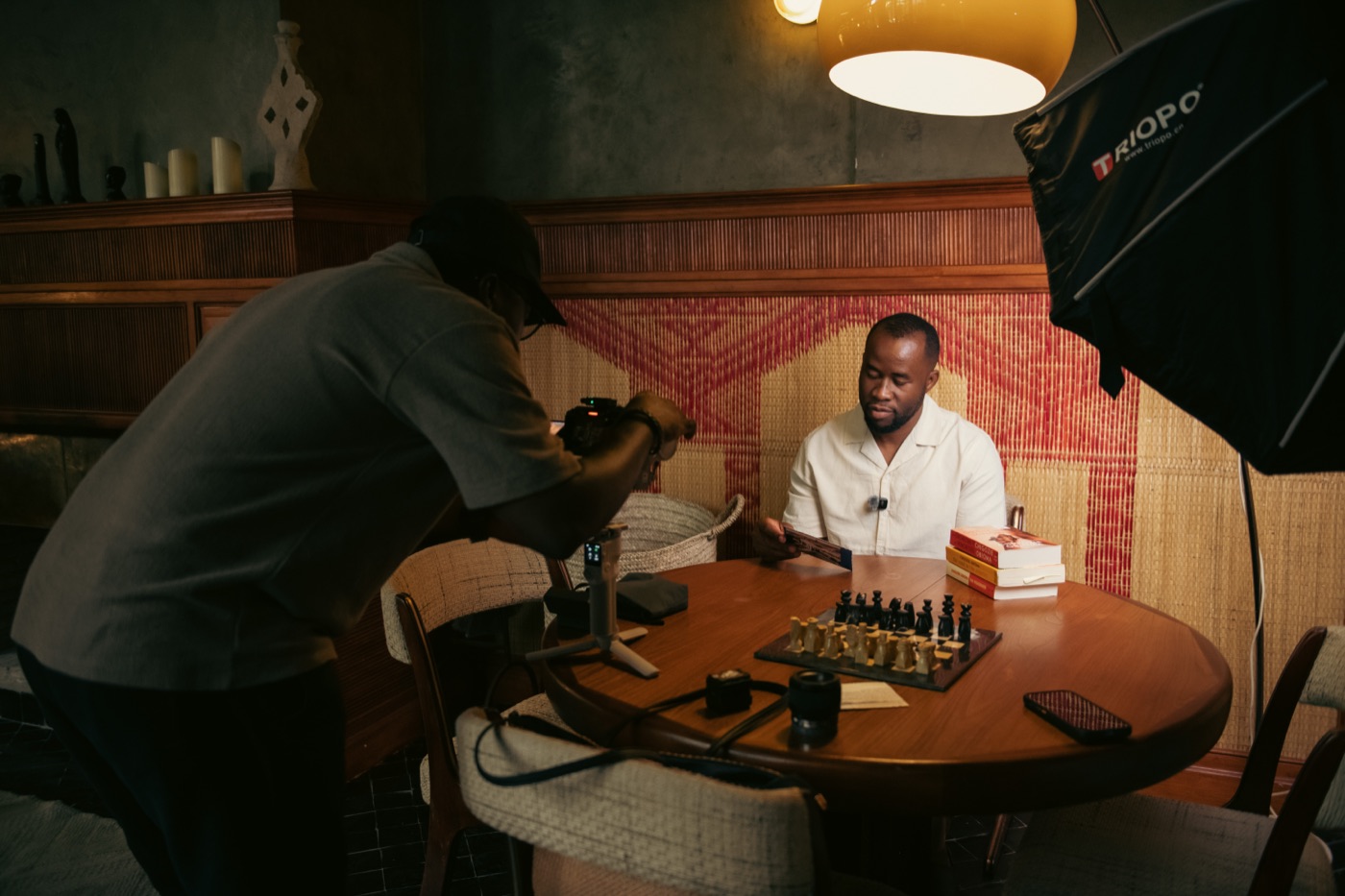 Directing an interview over a chess board in a riad lounge