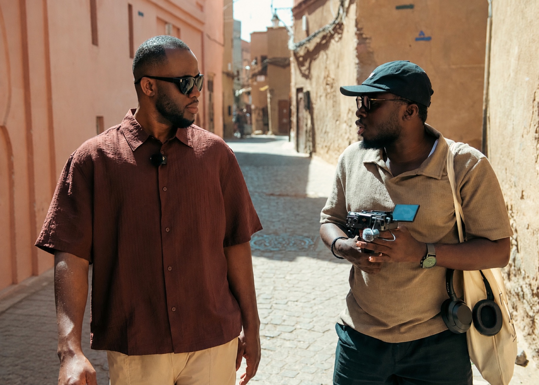 Expedition Hubert walking through the Marrakech Medina with his cinematographer