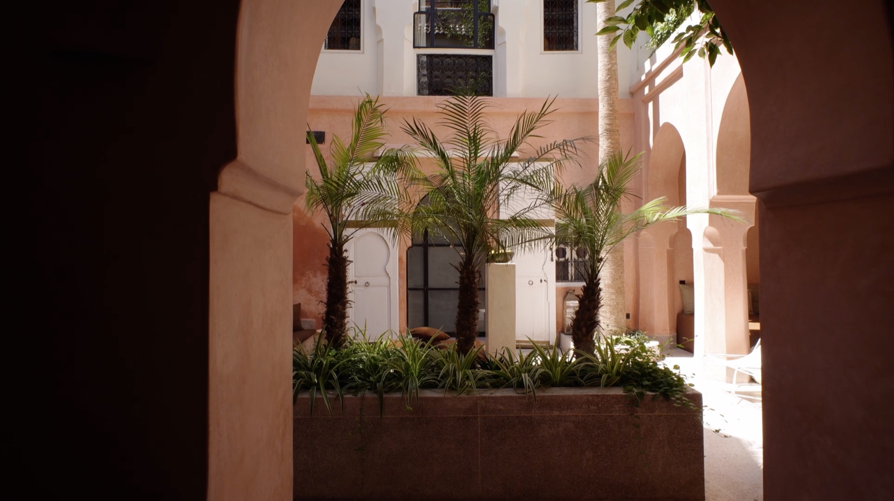 Central courtyard with palms seen through a keyhole arch