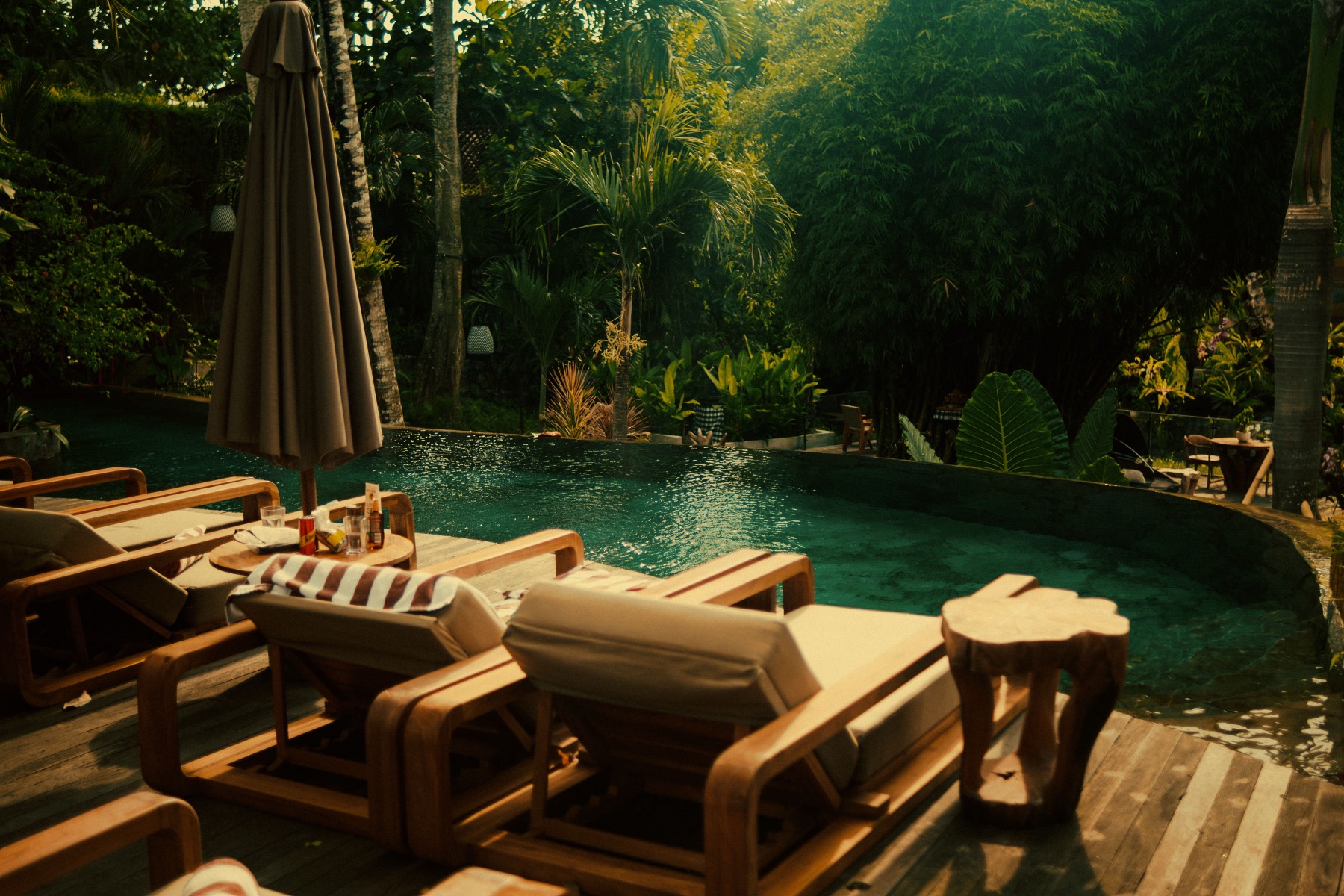 Ulaman Eco Luxury Resort — the pool and teak loungers under the jungle canopy